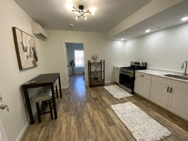a kitchen with stove cabinets and wooden floor