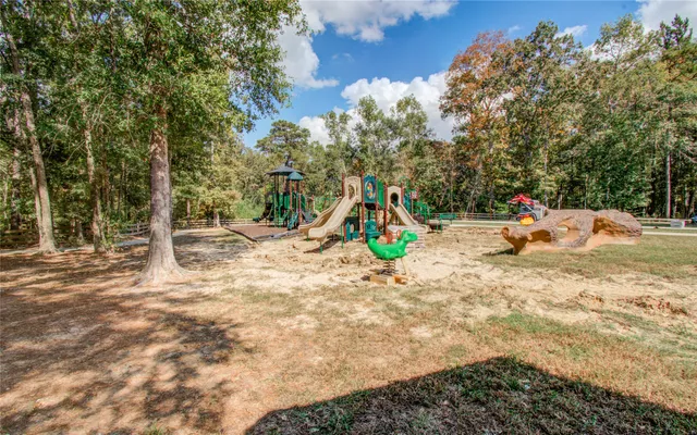 a view of a park with swings and slides
