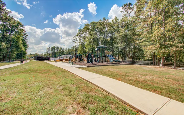 a view of a patio with a table chairs and a backyard