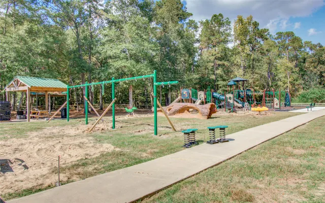 a front view of a house with a garden and trees