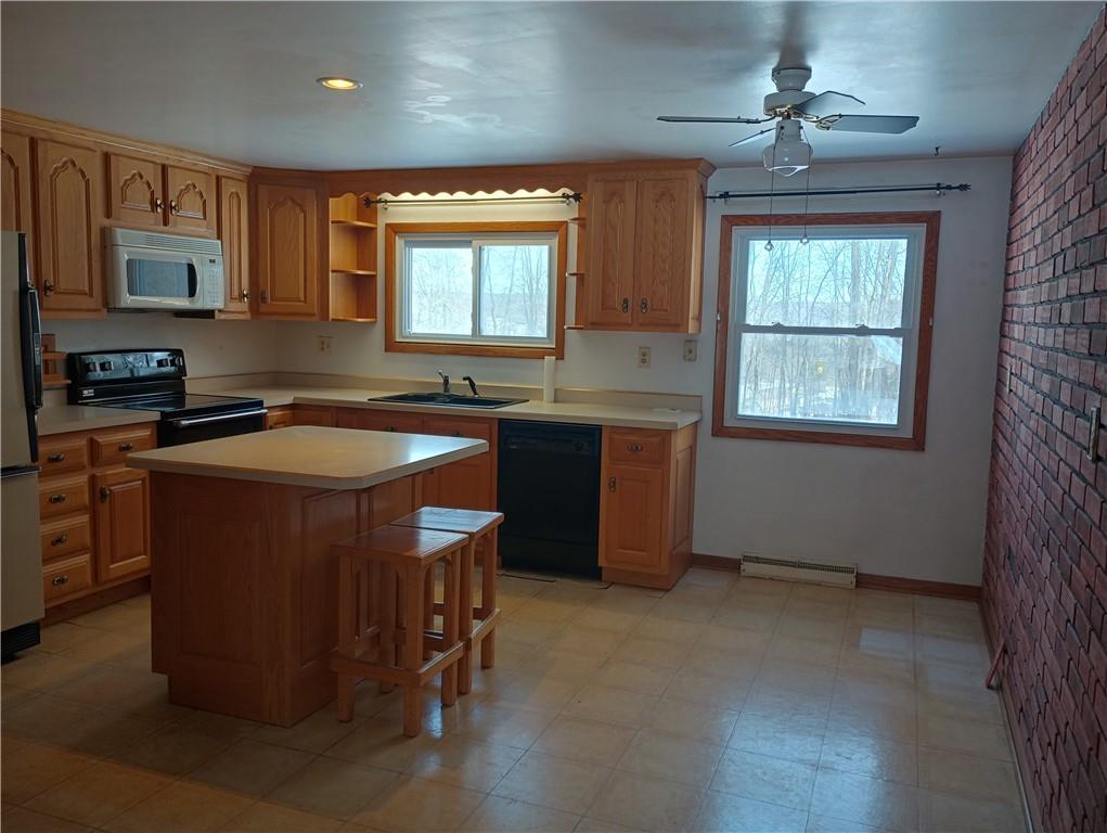 234 Baker Road Greenville, PA 16125 - Photo 4 of 16 a kitchen with stainless steel appliances granite countertop a sink stove and refrigerator