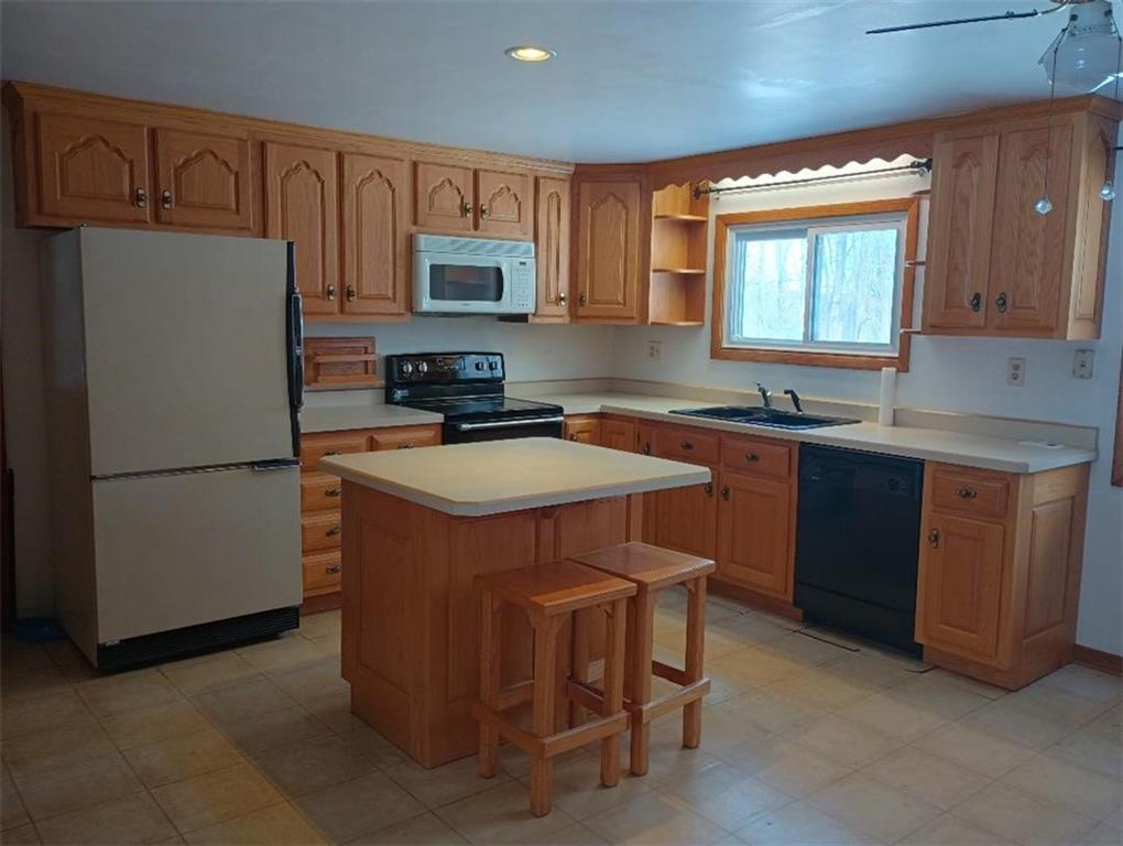234 Baker Road Greenville, PA 16125 - Photo 7 of 16 a kitchen with stainless steel appliances a sink a refrigerator a stove a microwave and cabinets