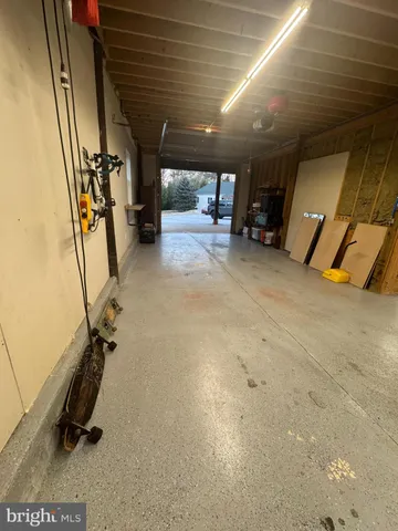a view of a garage with couple of cars parked in parking lot