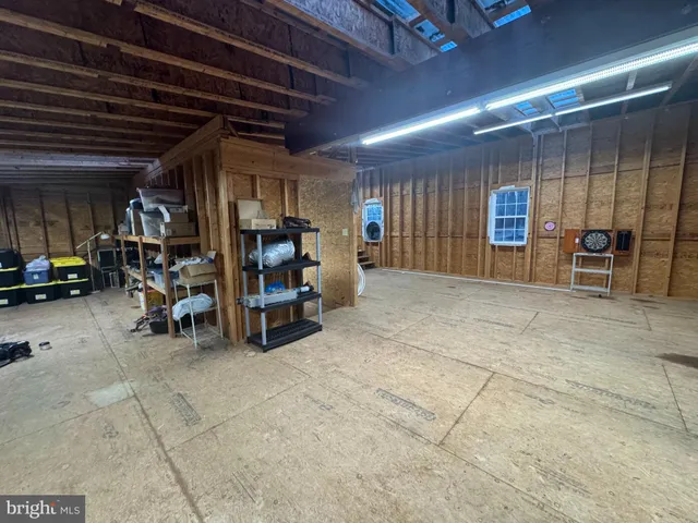 a view of an empty room with furniture and a kitchen