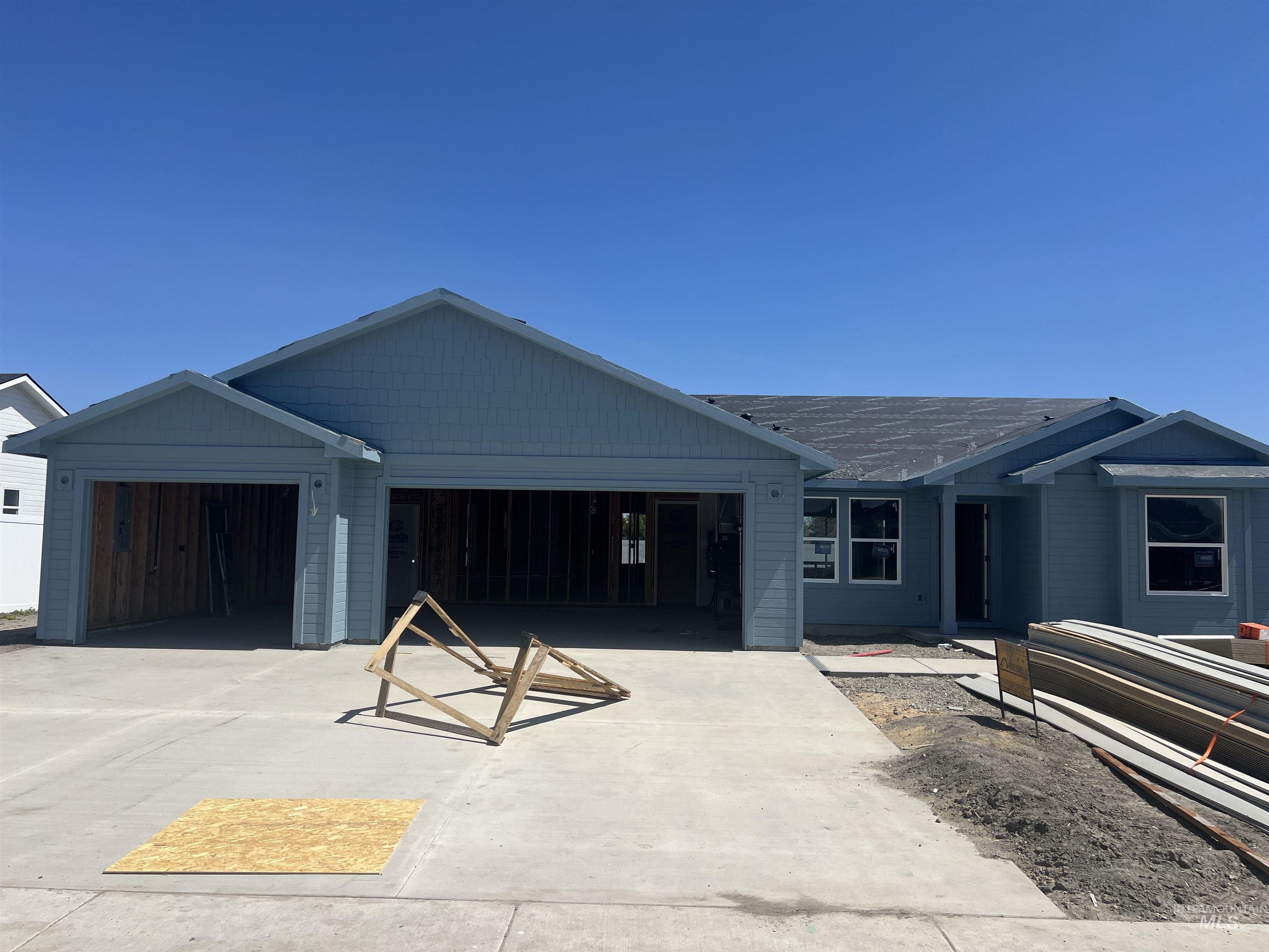 960 Campbell Street Vale, OR 97918 - Photo 1 of 45 Light blue siding exterior featuring multiple gables and a multi-car garage