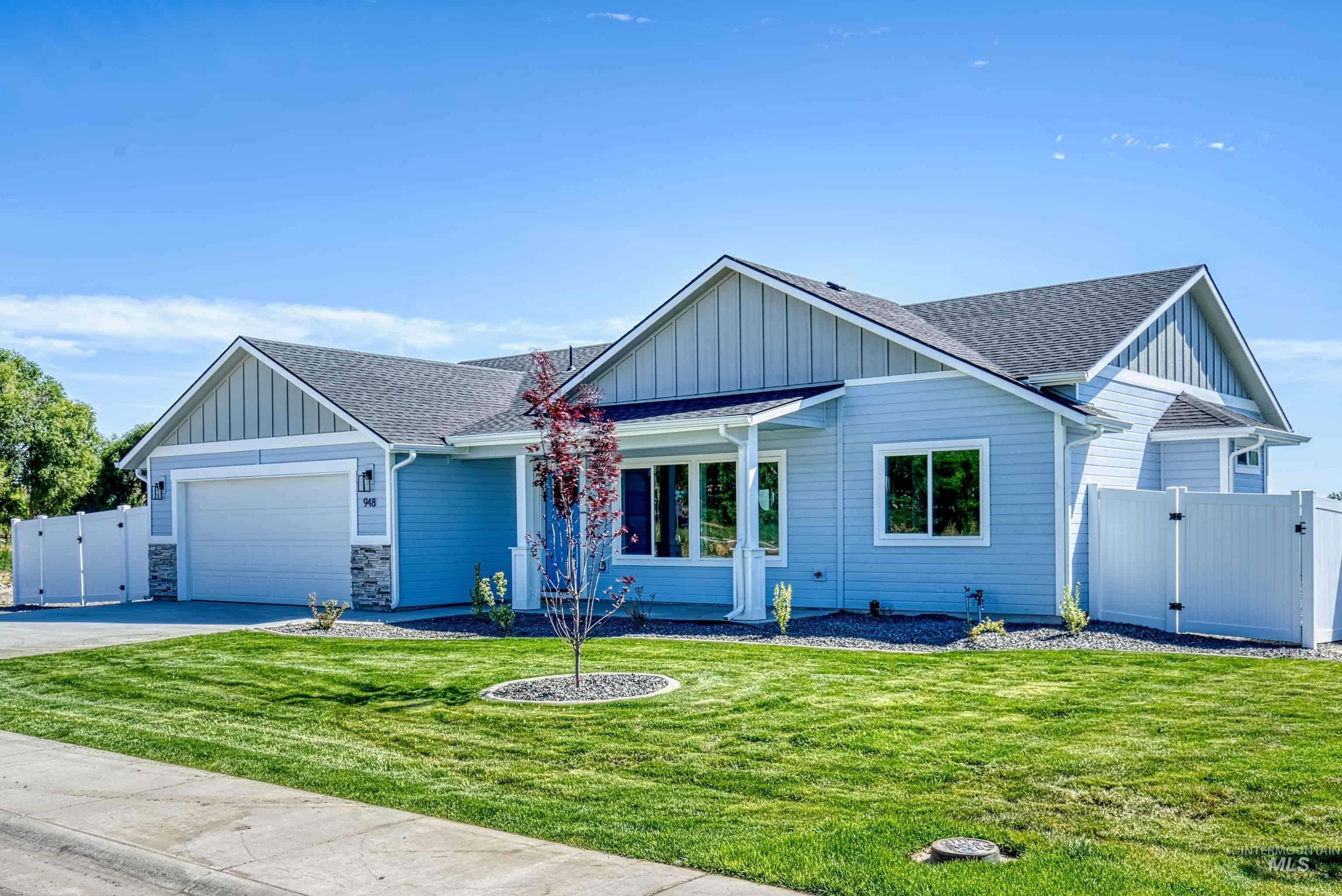 960 Campbell Street Vale, OR 97918 - Photo 2 of 49 Light blue siding exterior featuring a white garage door