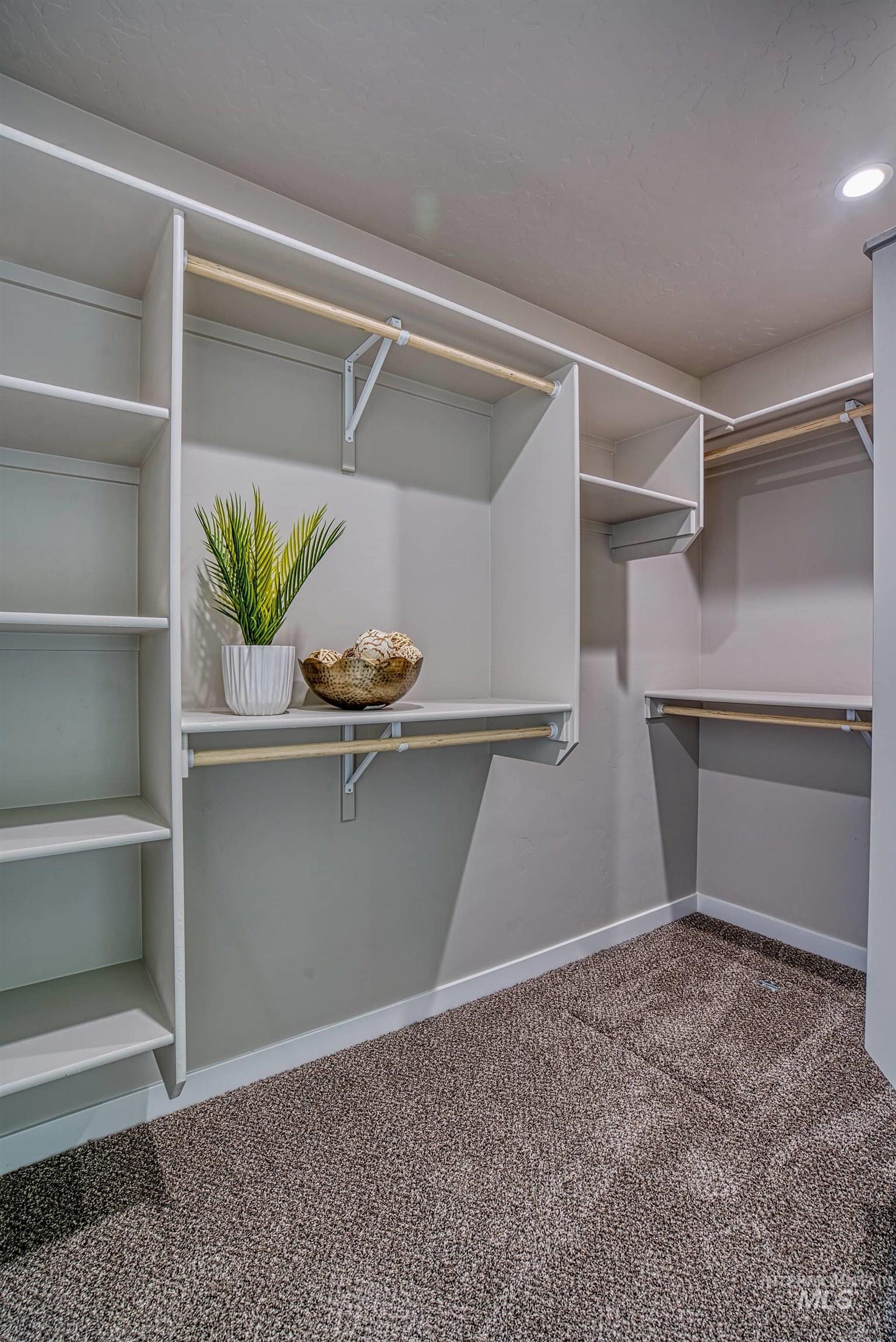 960 Campbell Street Vale, OR 97918 - Photo 22 of 49 Walk-in closet featuring built-in shelving, multiple hanging rods, and recessed lighting