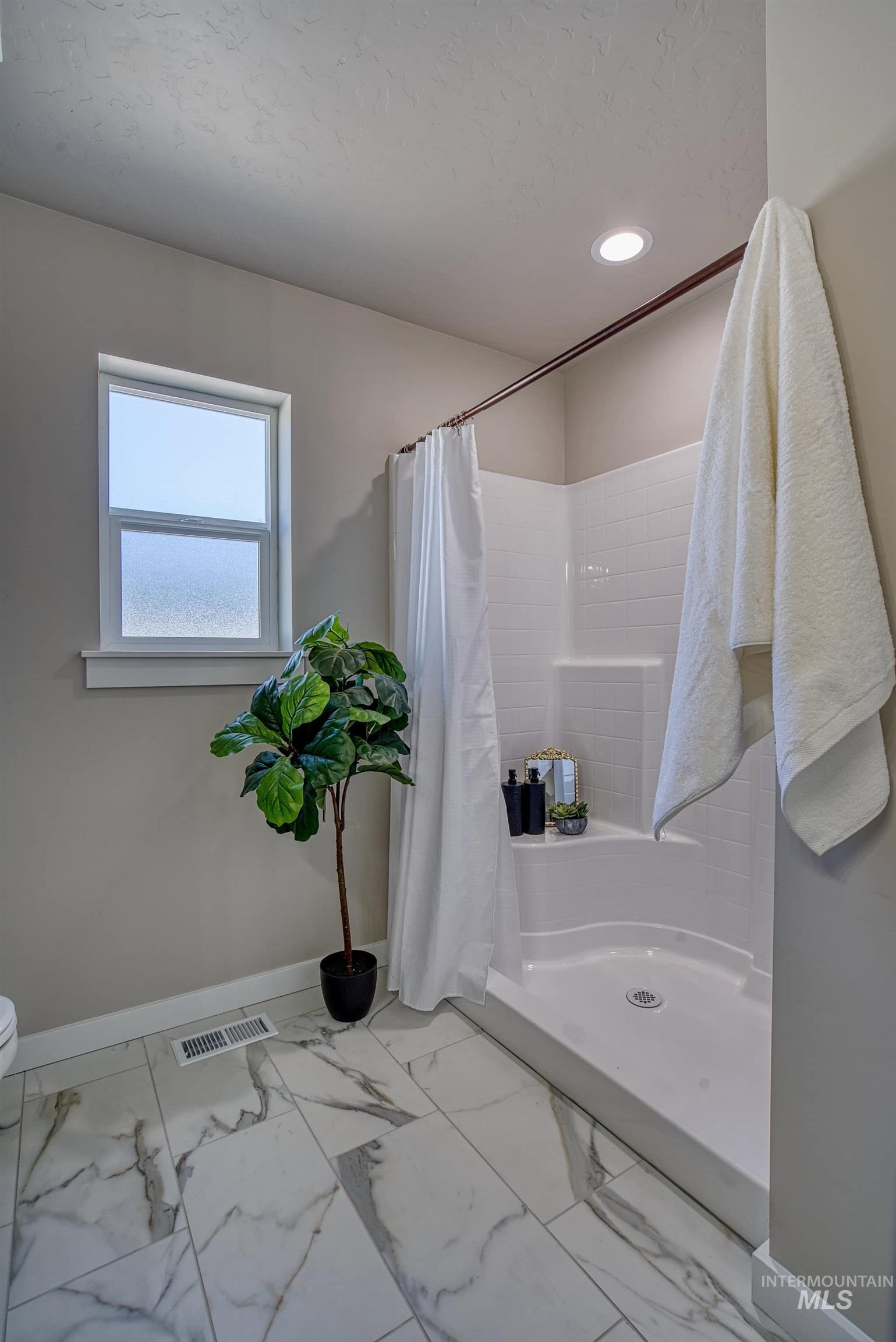 960 Campbell Street Vale, OR 97918 - Photo 28 of 49 Bathroom featuring a walk-in shower with white subway tile surround, recessed lighting, and a frosted window