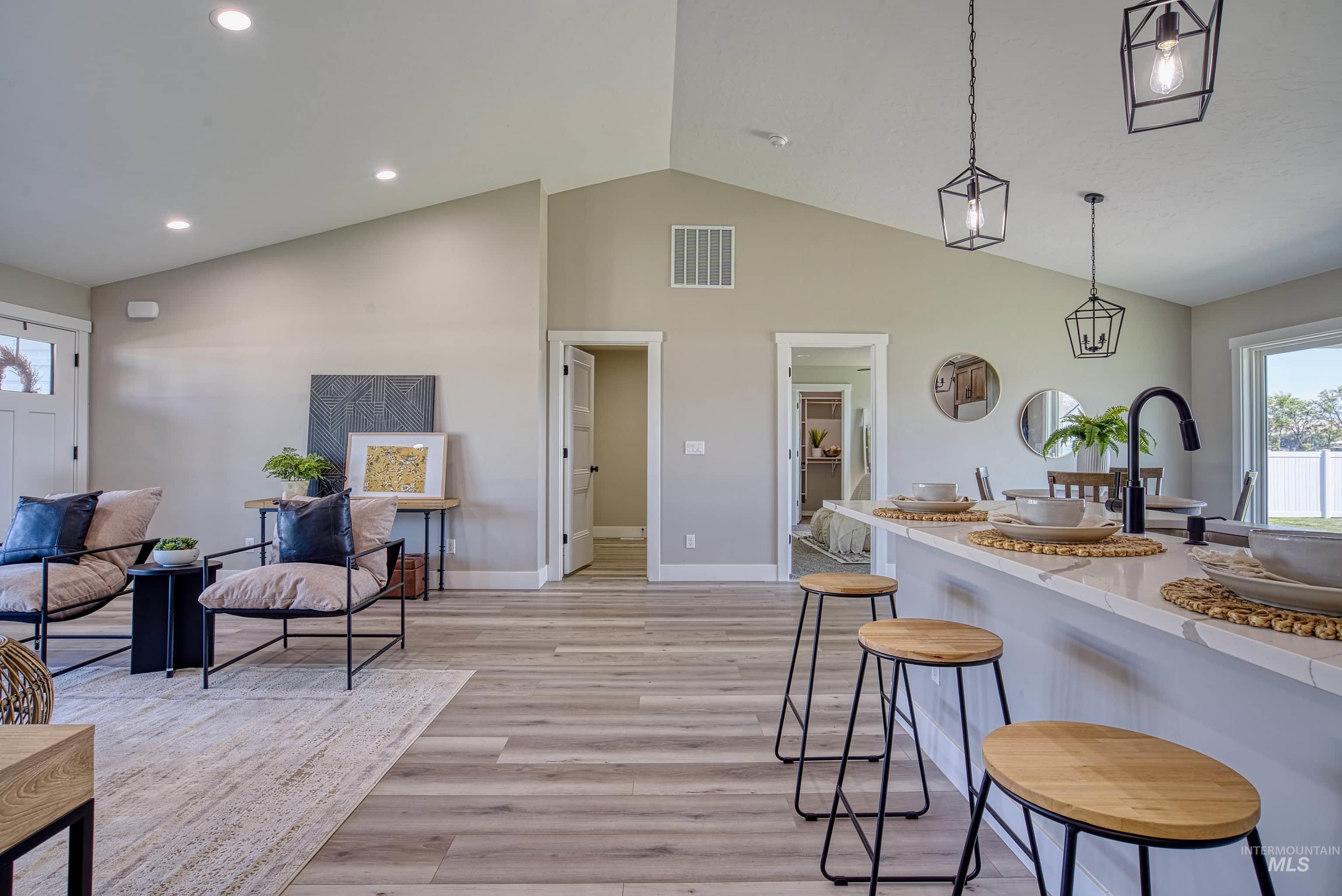960 Campbell Street Vale, OR 97918 - Photo 3 of 49 Open-concept living area featuring vaulted ceilings, recessed lighting, and wood-finish flooring