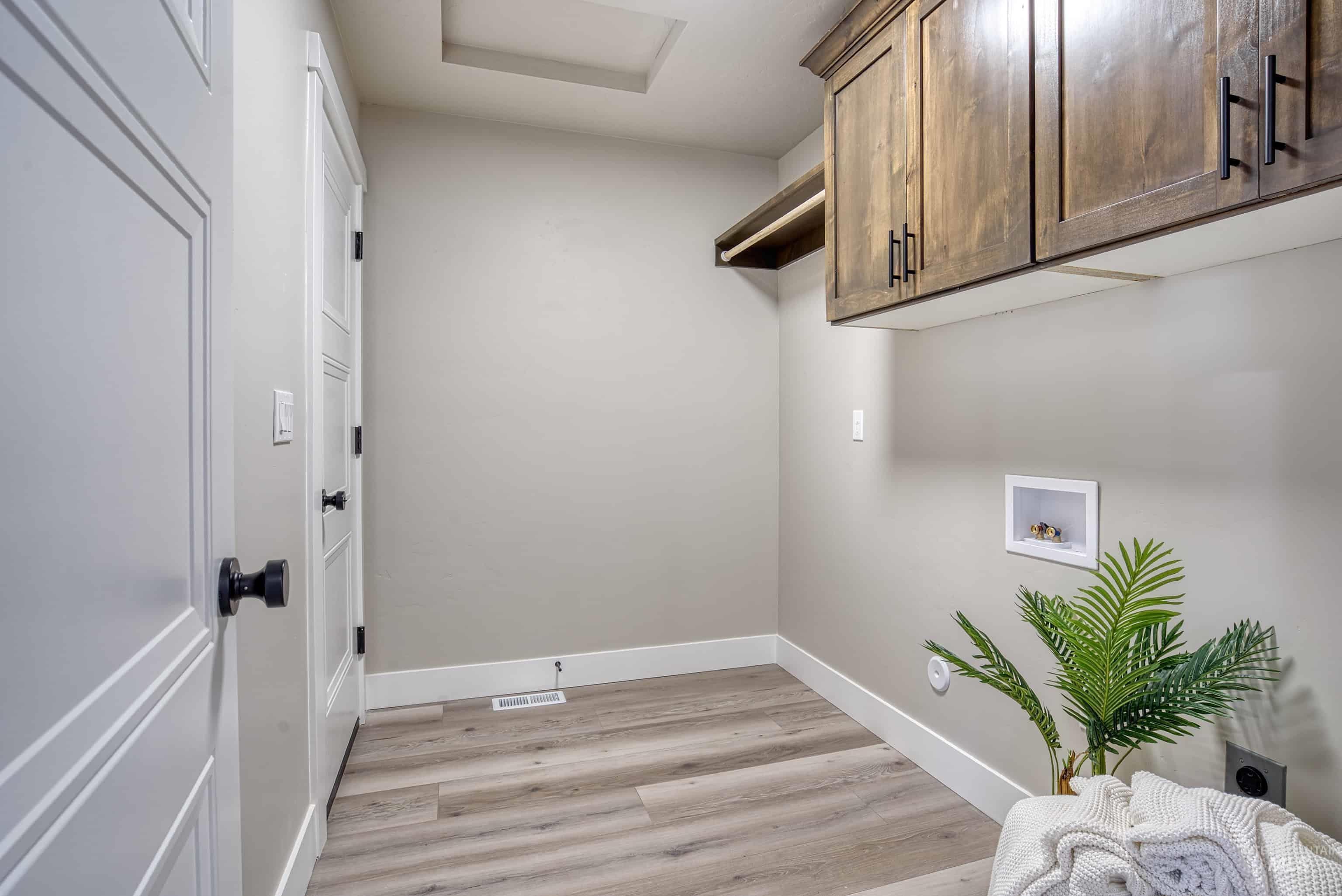 960 Campbell Street Vale, OR 97918 - Photo 33 of 49 Laundry area featuring wood-finish flooring, light grey walls, and white baseboards