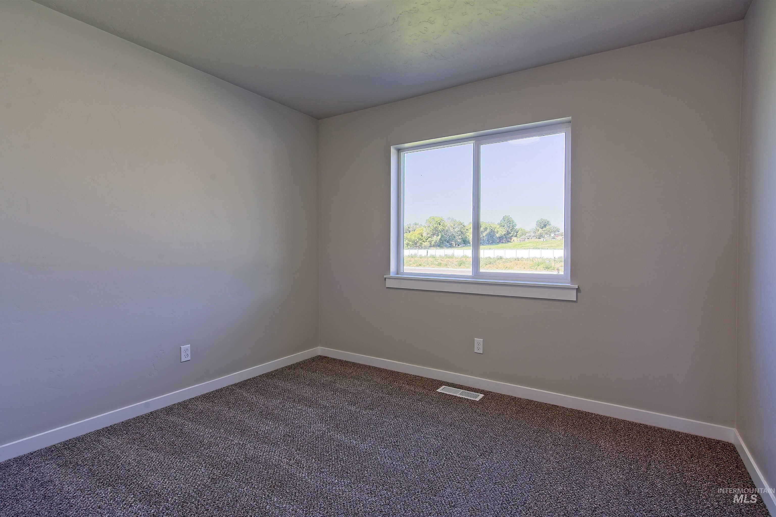 960 Campbell Street Vale, OR 97918 - Photo 36 of 49 Neutral-toned walls complement the dark textured carpeting