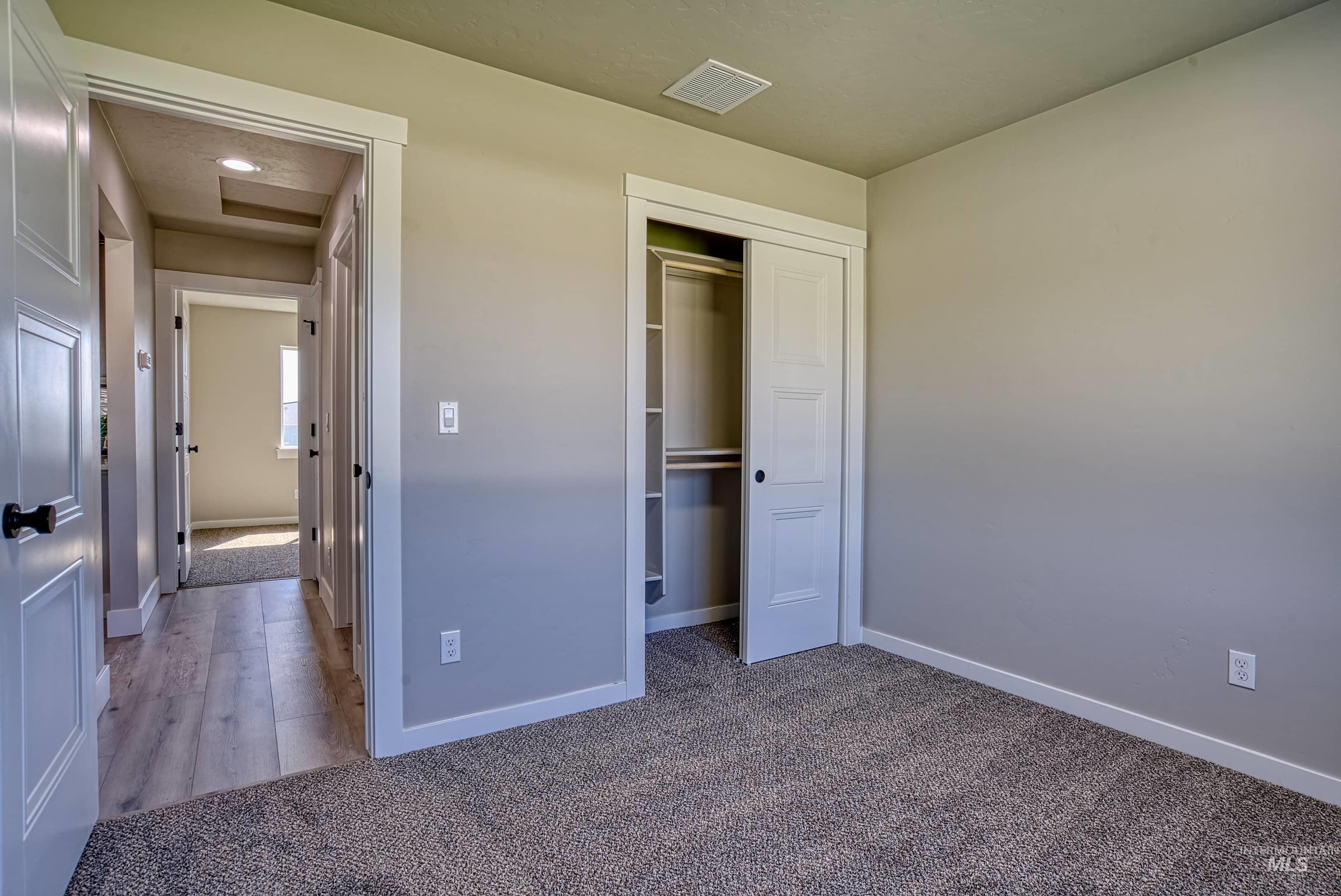 960 Campbell Street Vale, OR 97918 - Photo 37 of 49 Neutral-toned bedroom featuring plush carpeting and a bi-fold closet with shelving