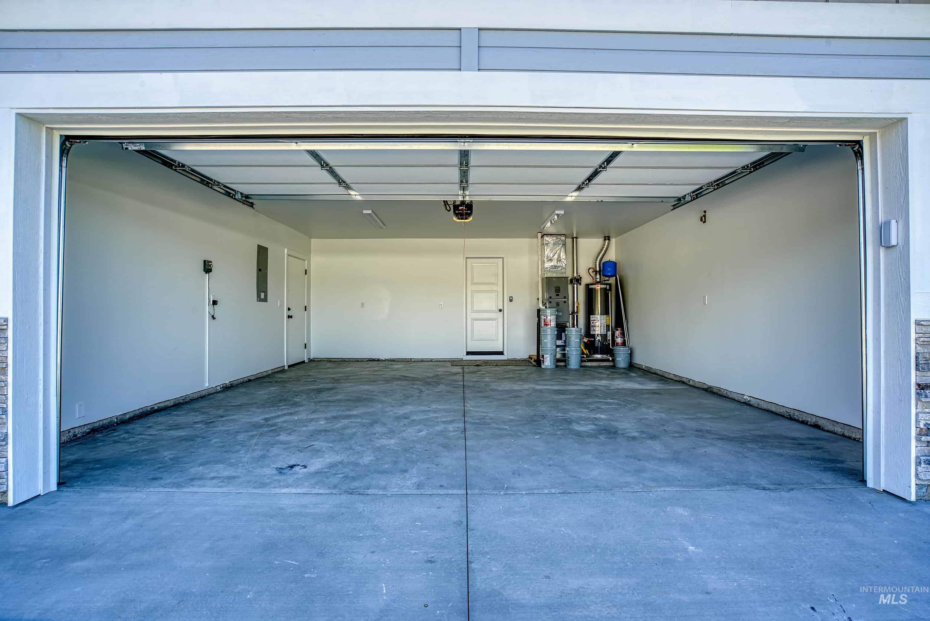 960 Campbell Street Vale, OR 97918 - Photo 40 of 49 Spacious garage featuring a concrete floor, light gray painted walls, and an overhead garage door mechanism