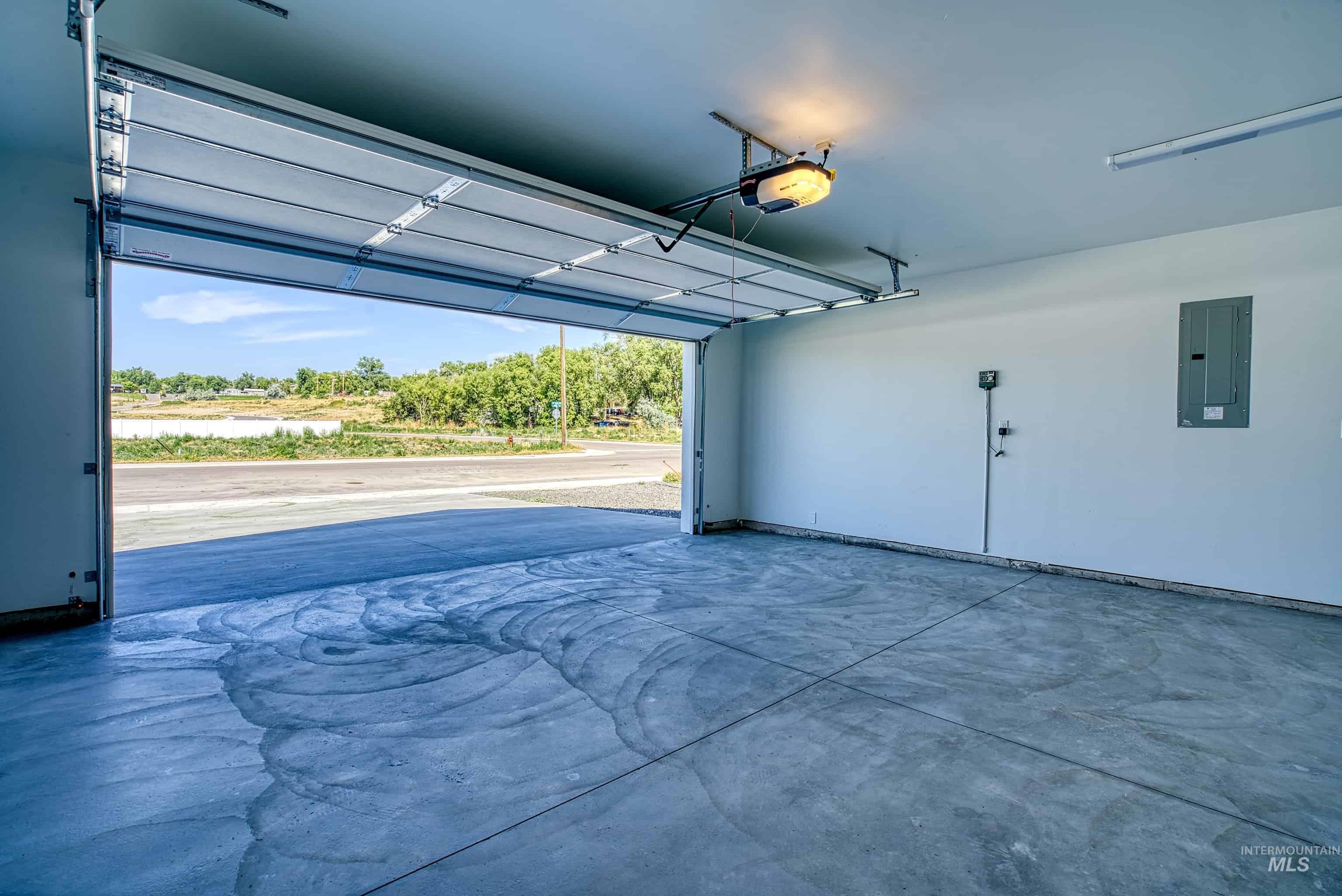 960 Campbell Street Vale, OR 97918 - Photo 41 of 49 Spacious garage featuring a concrete floor, automatic garage door opener, and interior lighting
