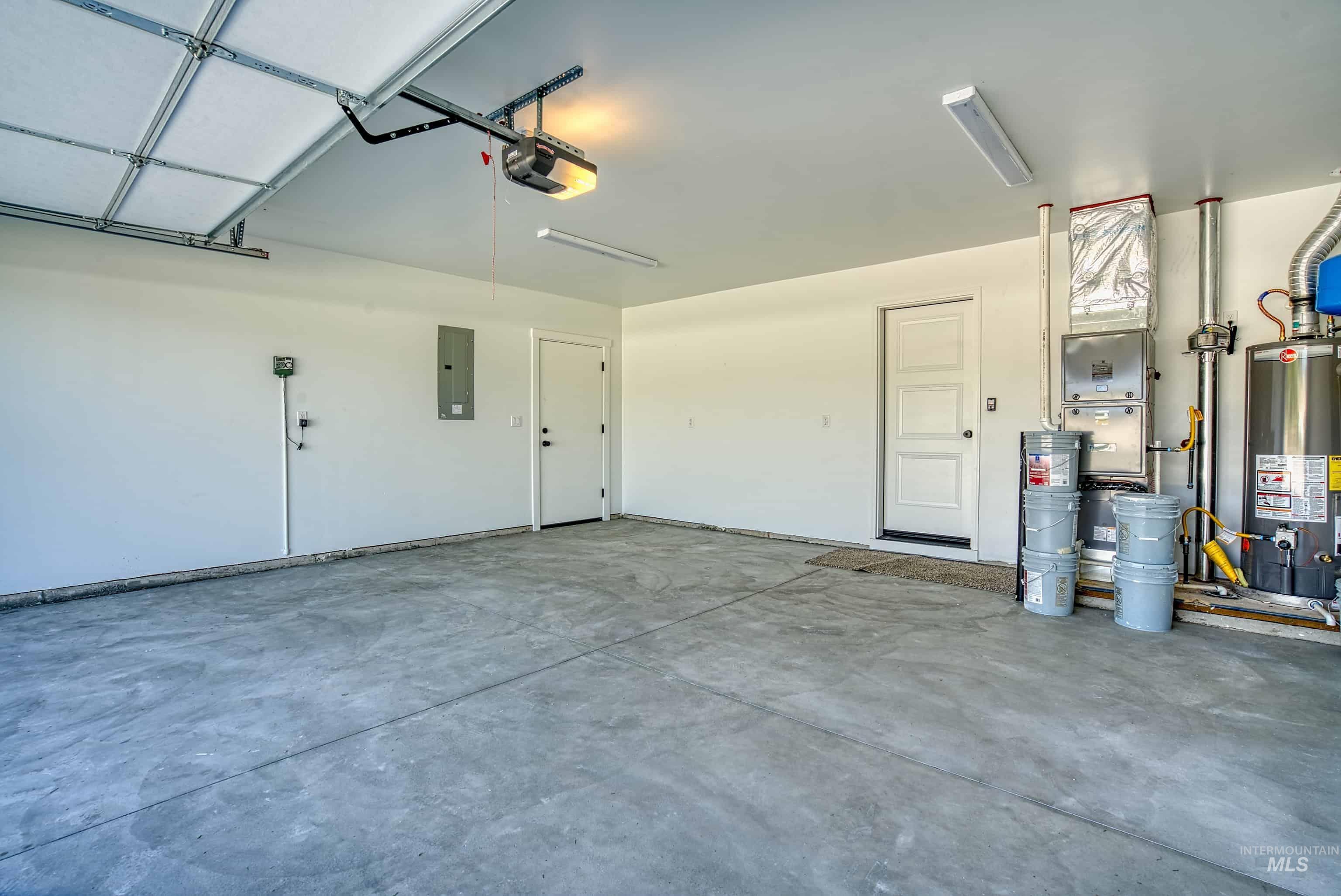 960 Campbell Street Vale, OR 97918 - Photo 42 of 49 Spacious garage featuring a concrete floor, white painted walls, and a garage door opener system