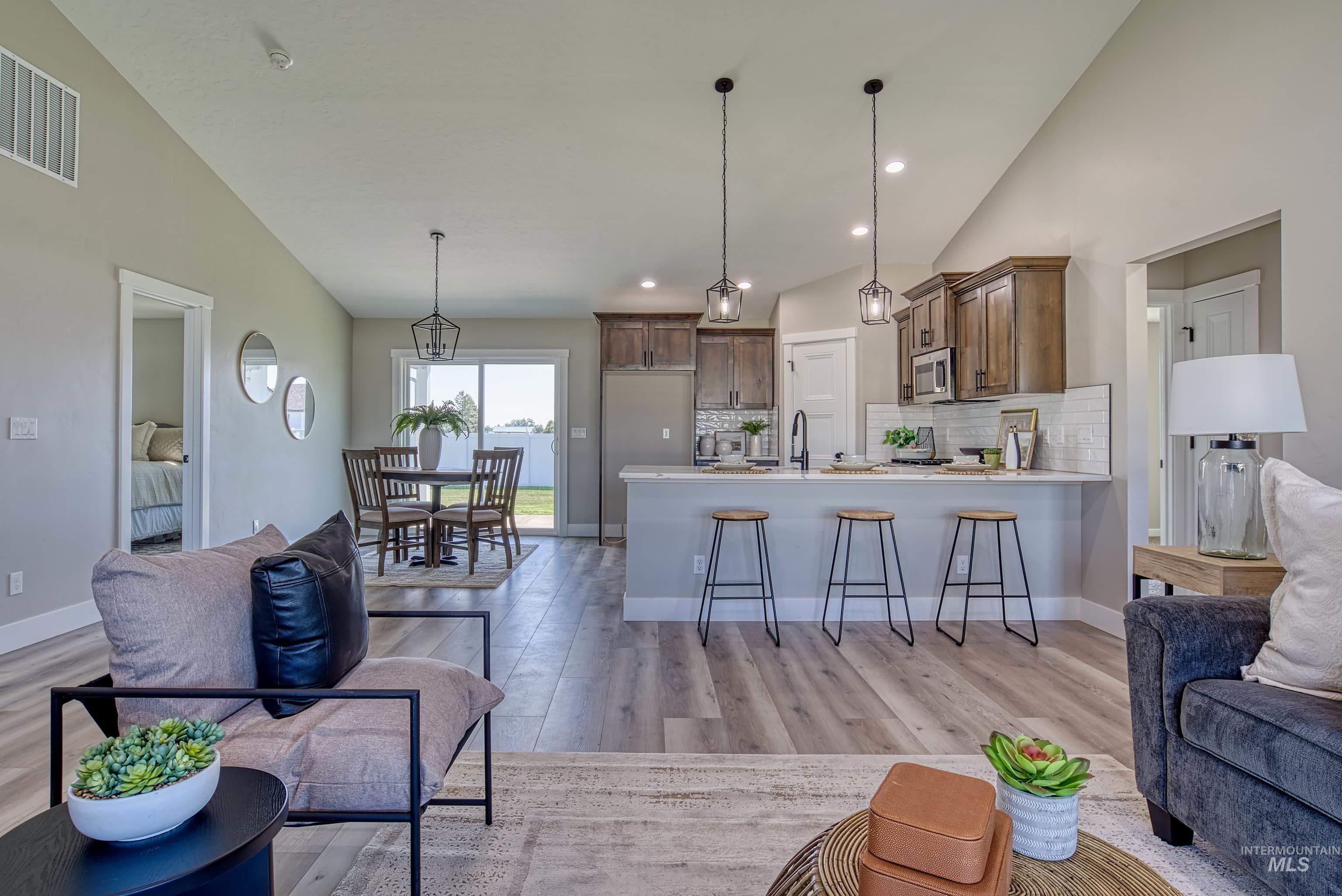 960 Campbell Street Vale, OR 97918 - Photo 5 of 49 Vaulted ceilings highlight the open-concept living space with wood-finish flooring