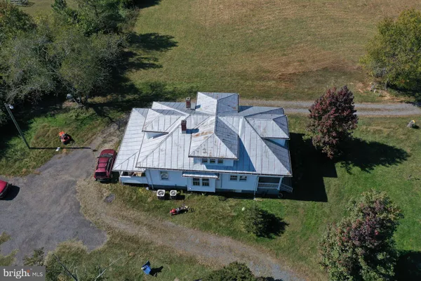 an aerial view of a house with a yard