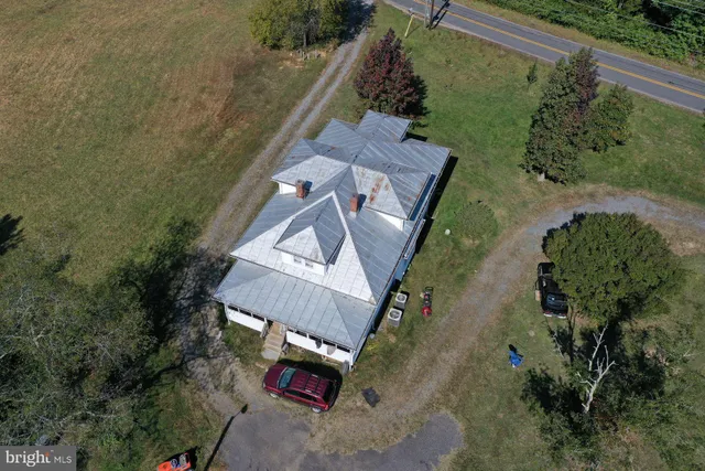 an aerial view of a house with a yard