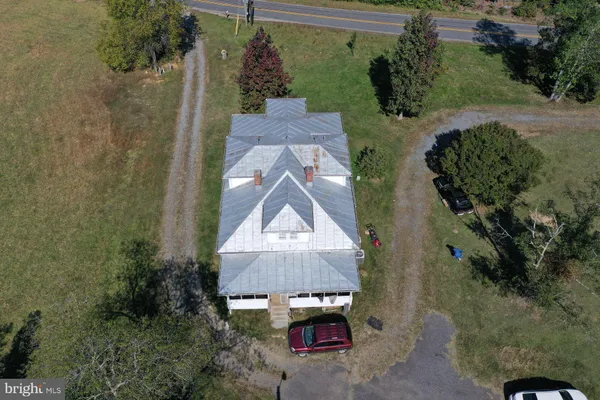 an aerial view of a house with a yard and garden
