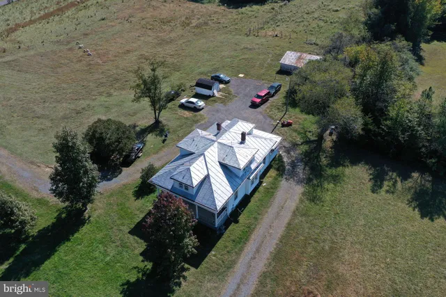 an aerial view of a house with a yard