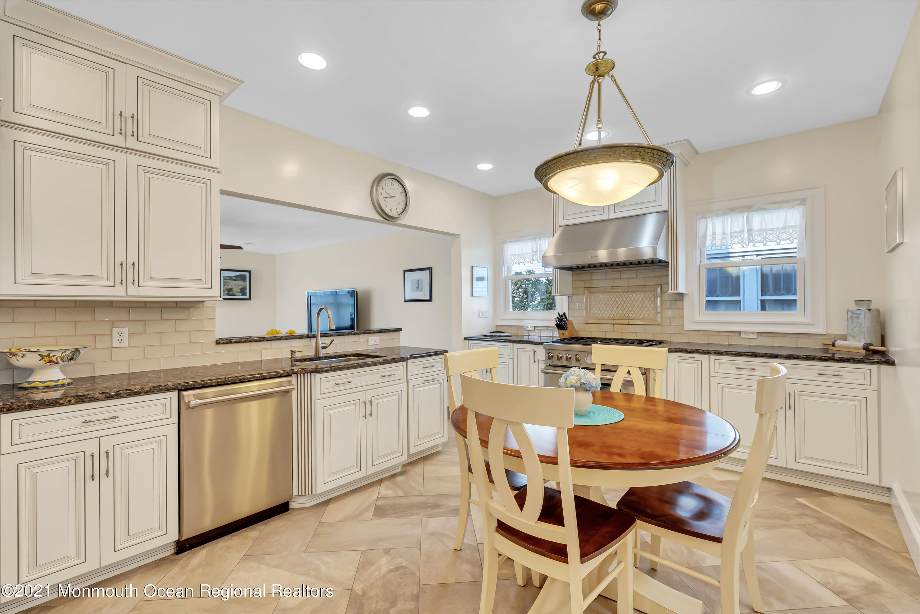 236 Allen Avenue Allenhurst, NJ 07711 - Photo 26 of 46 a kitchen with center island table and chairs in it