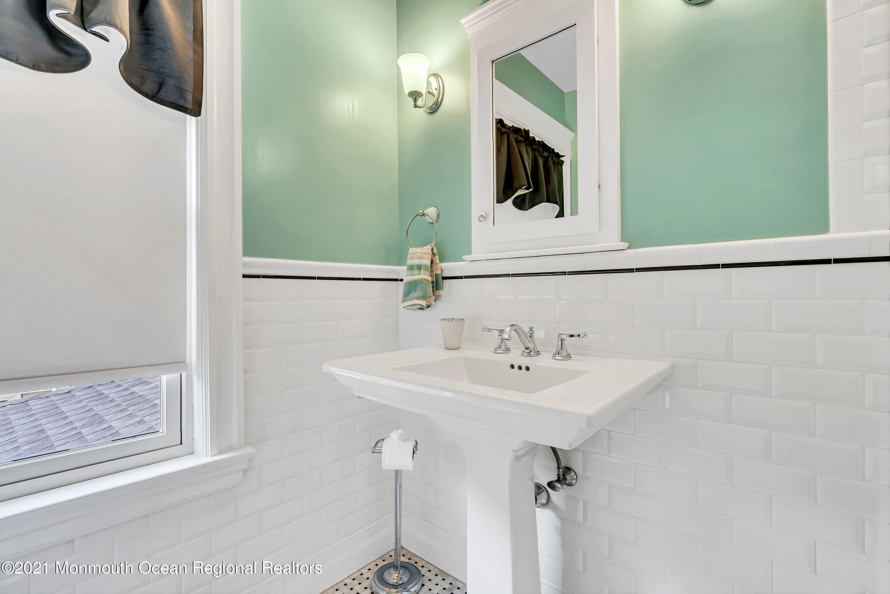 236 Allen Avenue Allenhurst, NJ 07711 - Photo 36 of 46 a bathroom with a sink and a mirror