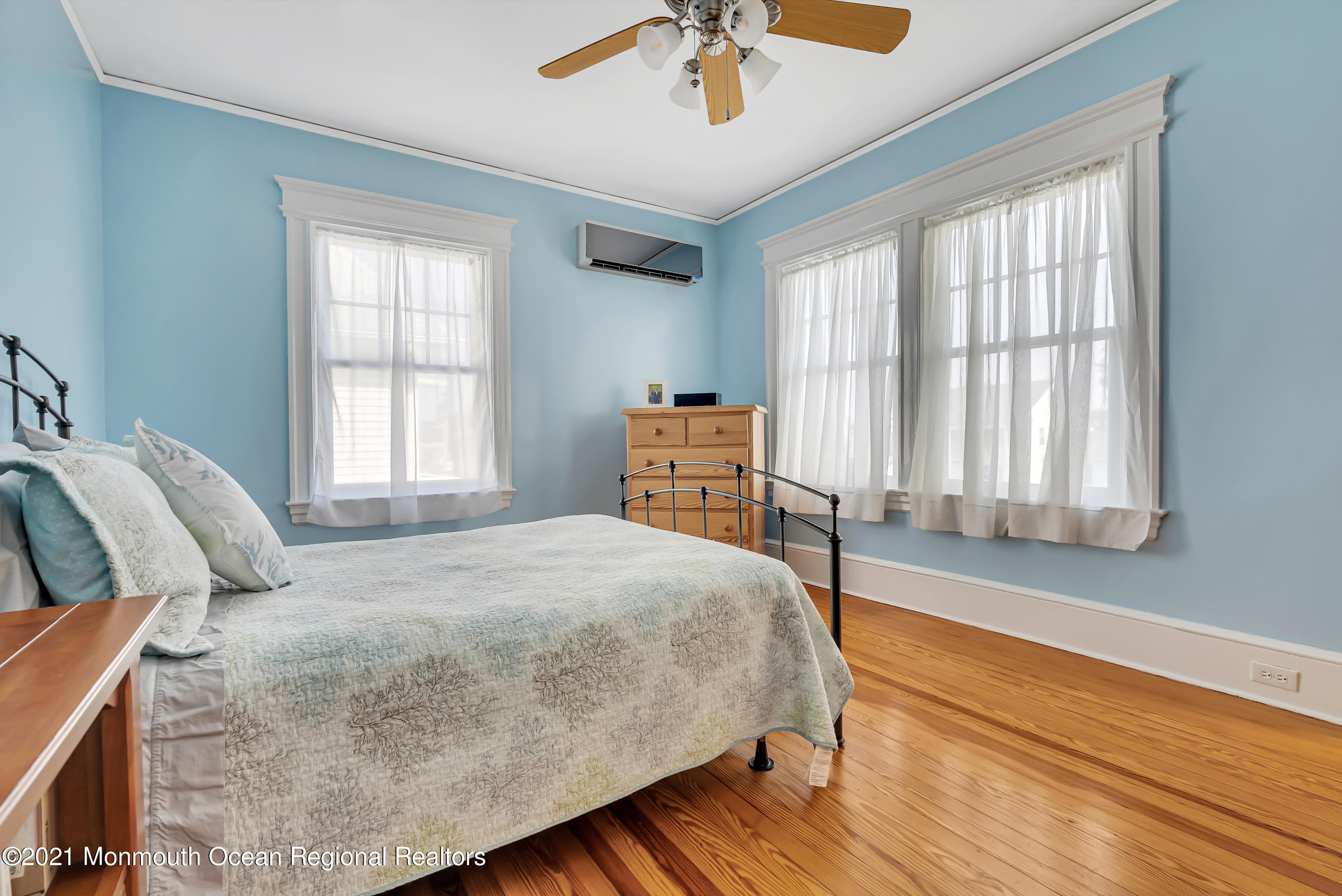 236 Allen Avenue Allenhurst, NJ 07711 - Photo 37 of 46 a bedroom with a bed and a chandelier
