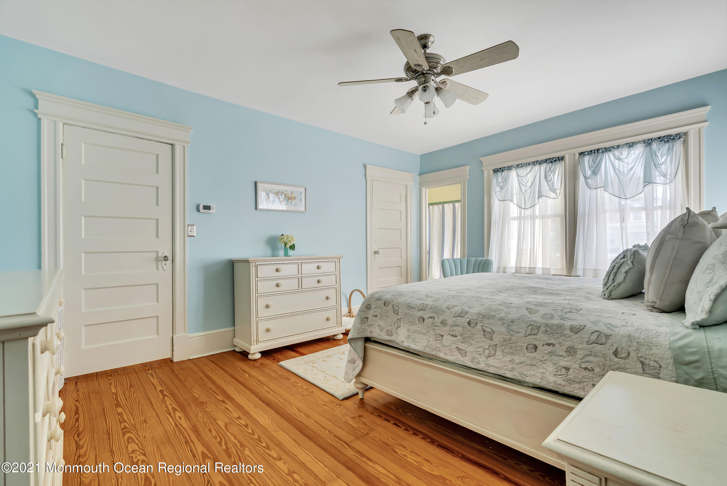 236 Allen Avenue Allenhurst, NJ 07711 - Photo 41 of 46 a bedroom with a bed and a chandelier