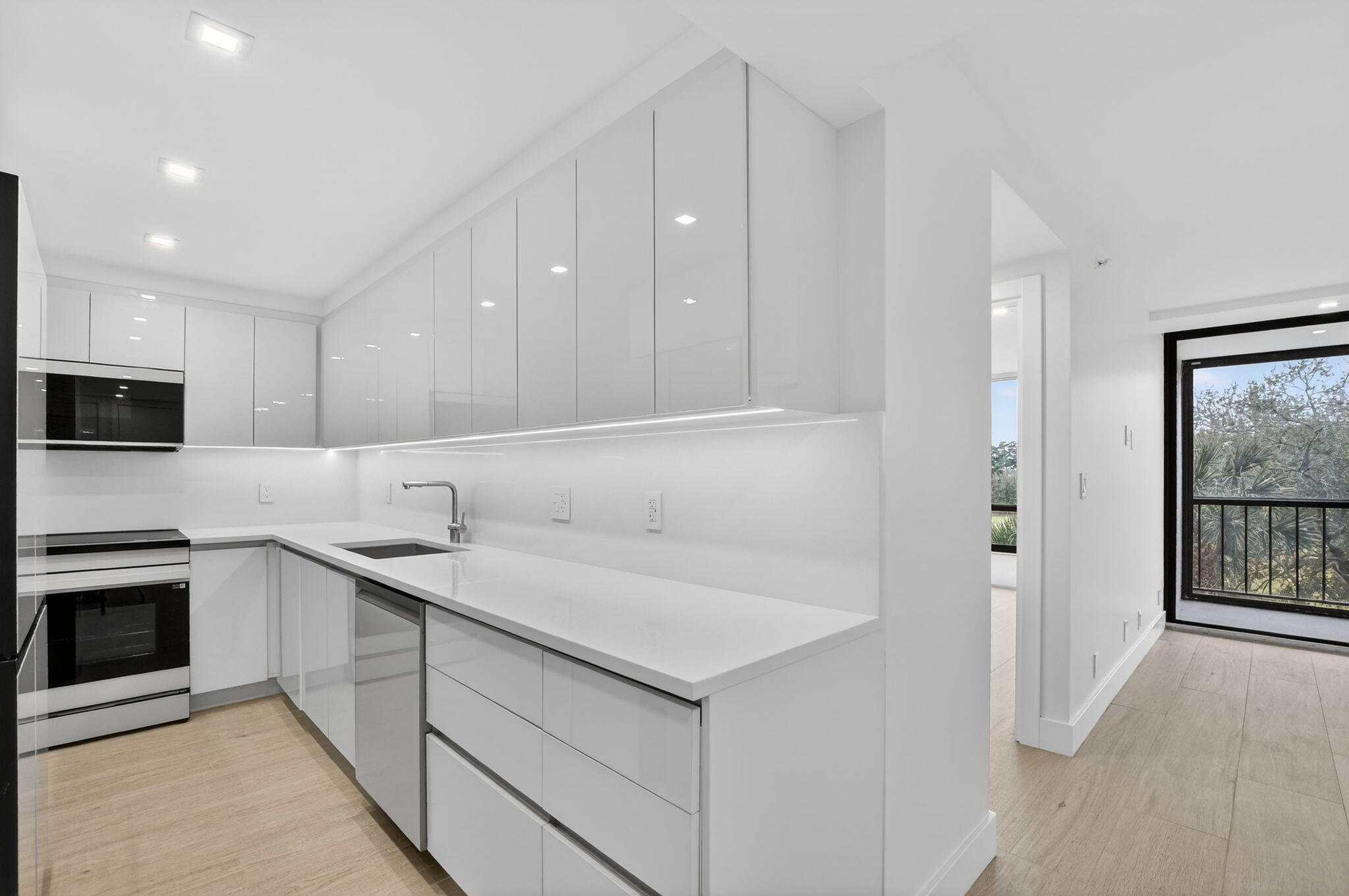 7835 Lakeside Boulevard, Unit 946 Boca Raton, FL 33434 - Photo 2 of 20 a kitchen with stainless steel appliances granite countertop a sink and a stove top oven