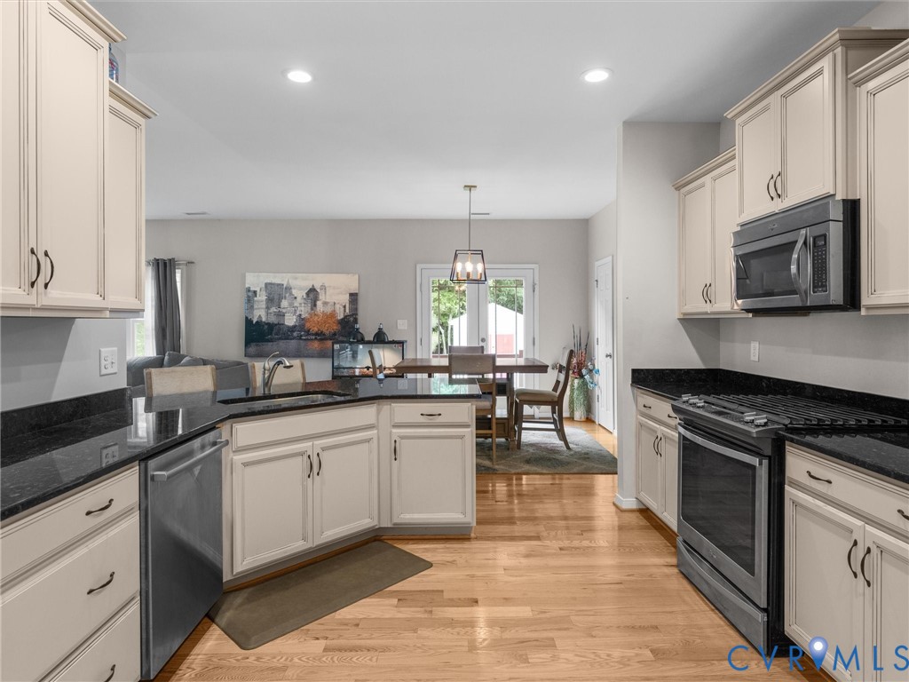 10824 Avening Road Chesterfield, VA 23832 - Photo 10 of 47 a kitchen with stainless steel appliances granite countertop a stove a sink and a microwave