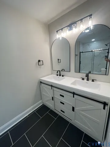 a bathroom with a double vanity sink and a mirror