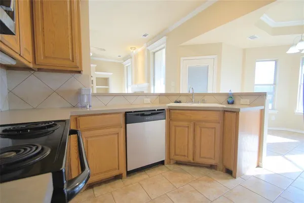 a kitchen with a stove sink and cabinets