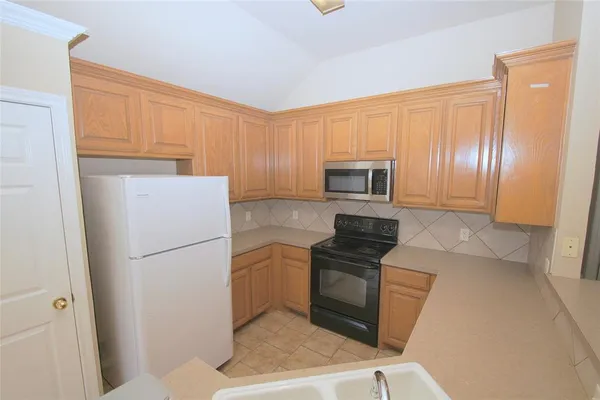 a kitchen with a refrigerator sink and microwave