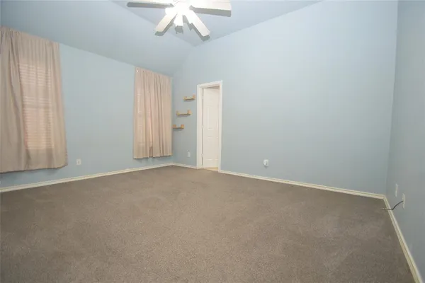 an empty room with a chandelier fan