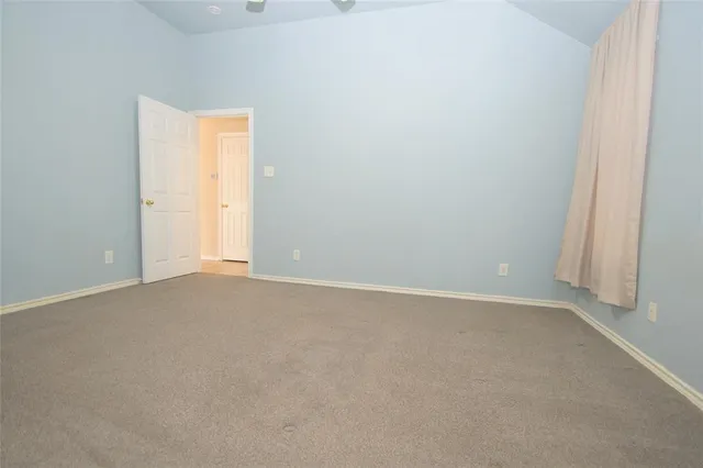 a view of an empty room and chandelier