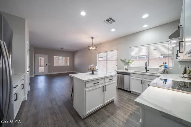 a kitchen with a sink stove and cabinets