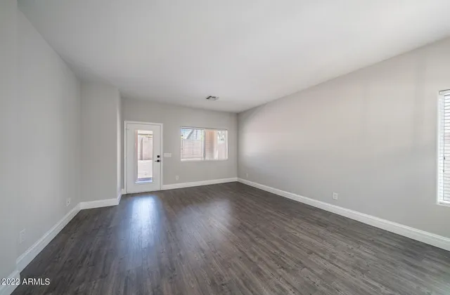 a view of a hallway with wooden floor and a potted plant