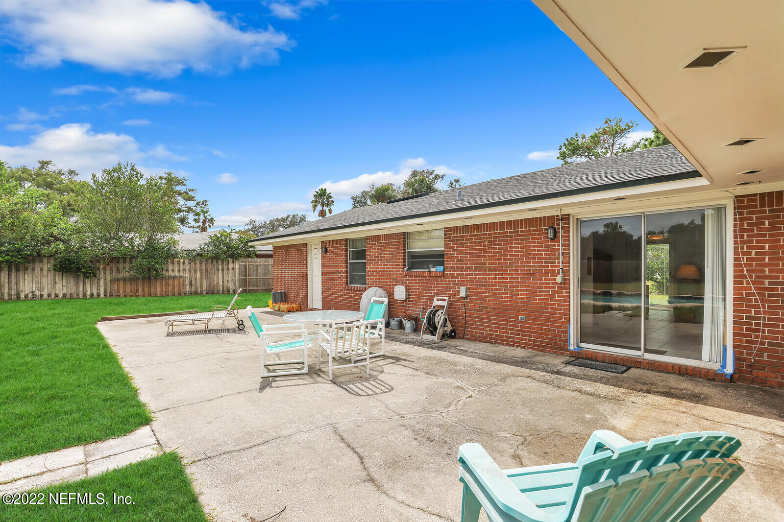 13 Sailfish Drive Ponte Vedra Beach, FL 32082 - Photo 32 of 34 a view of a patio with table and chairs with wooden fence