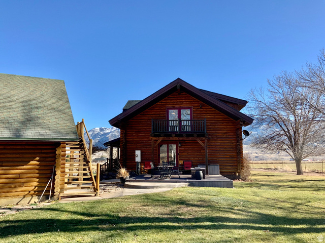 76 Highway 118 Monroe, UT 84754 - Photo 74 of 76 Back of property with log exterior, a patio, stairs, and a lawn