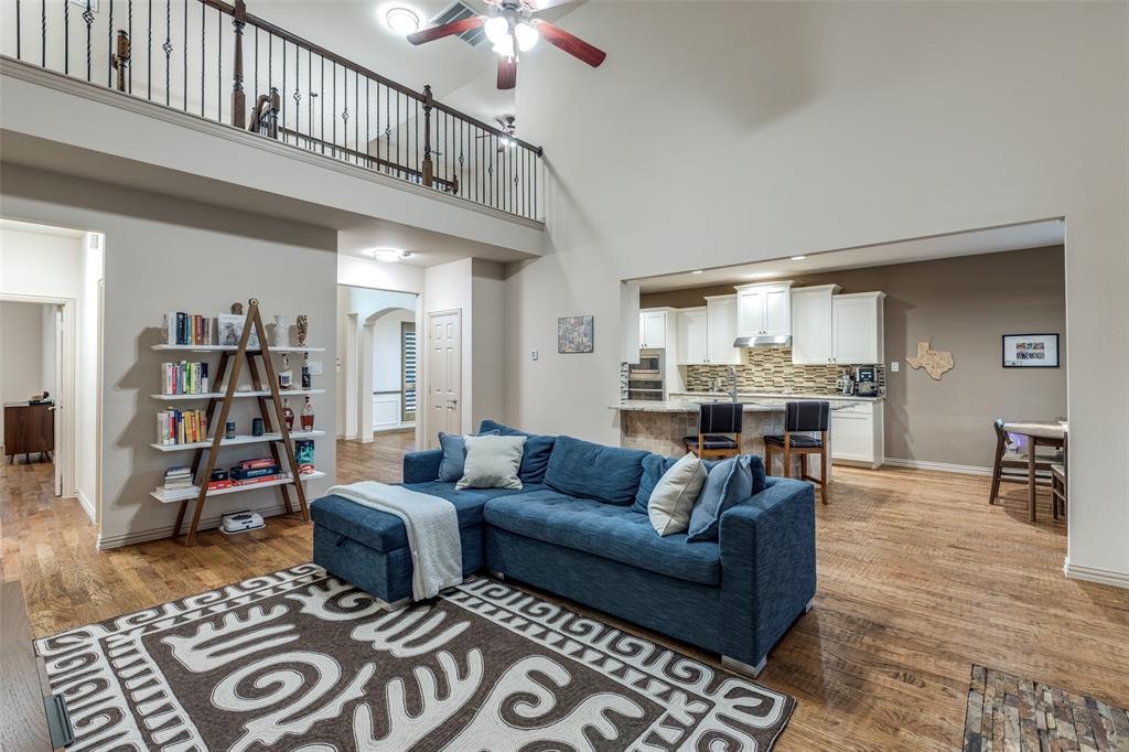 1445 Stagecoach Way Frisco, TX 75033 - Photo 13 of 39 a living room with furniture a rug and a bookshelf