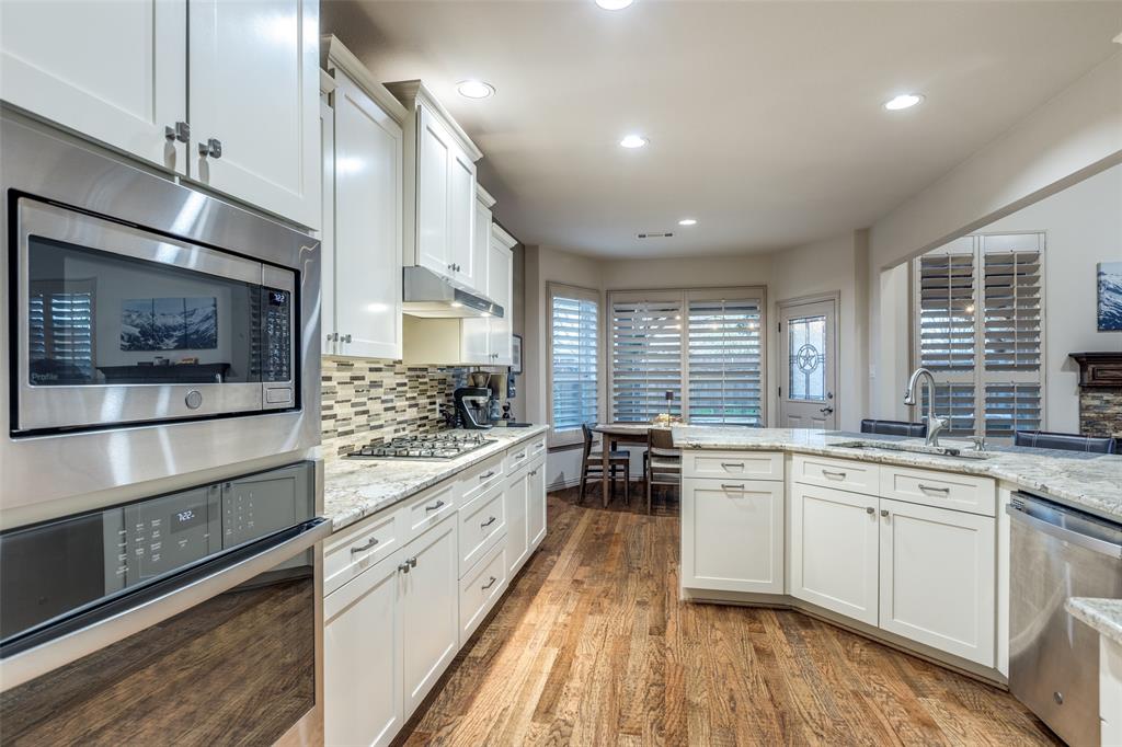 1445 Stagecoach Way Frisco, TX 75033 - Photo 17 of 39 a large kitchen with a large window and stainless steel appliances