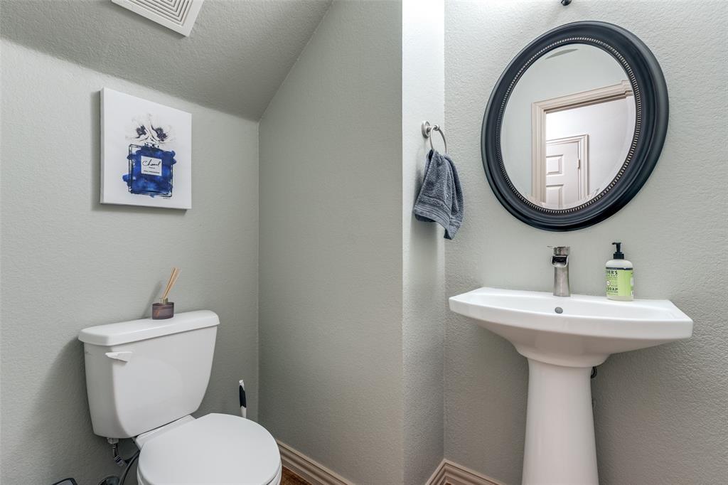 1445 Stagecoach Way Frisco, TX 75033 - Photo 19 of 39 a bathroom with a toilet a sink and a mirror