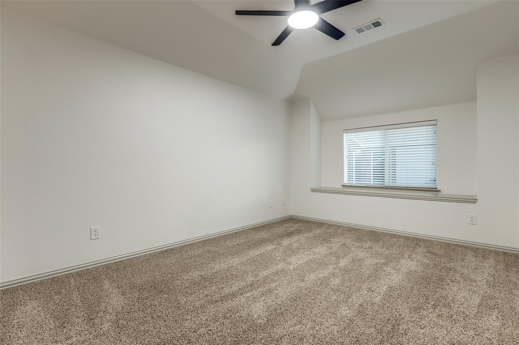 1445 Stagecoach Way Frisco, TX 75033 - Photo 30 of 39 an empty room with a chandelier fan and windows