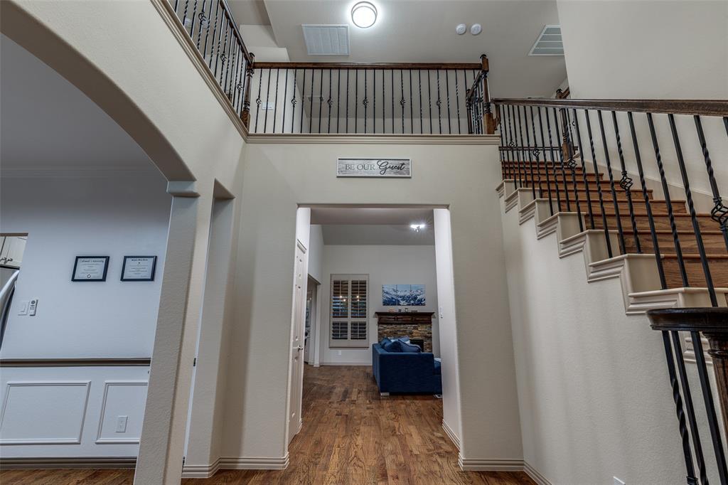 1445 Stagecoach Way Frisco, TX 75033 - Photo 7 of 39 a view of a hallway with wooden floor and staircase