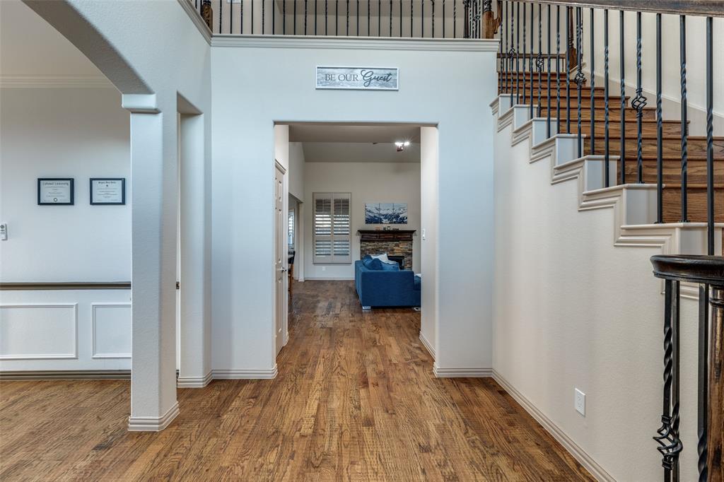1445 Stagecoach Way Frisco, TX 75033 - Photo 9 of 39 a view of a hallway with wooden floor and a living room