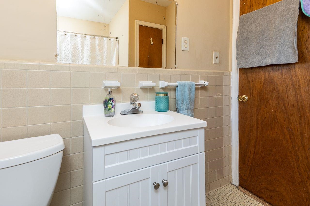 1632 Ivy Road Memphis, TN 38117 - Photo 11 of 14 a bathroom with a sink a toilet and mirror