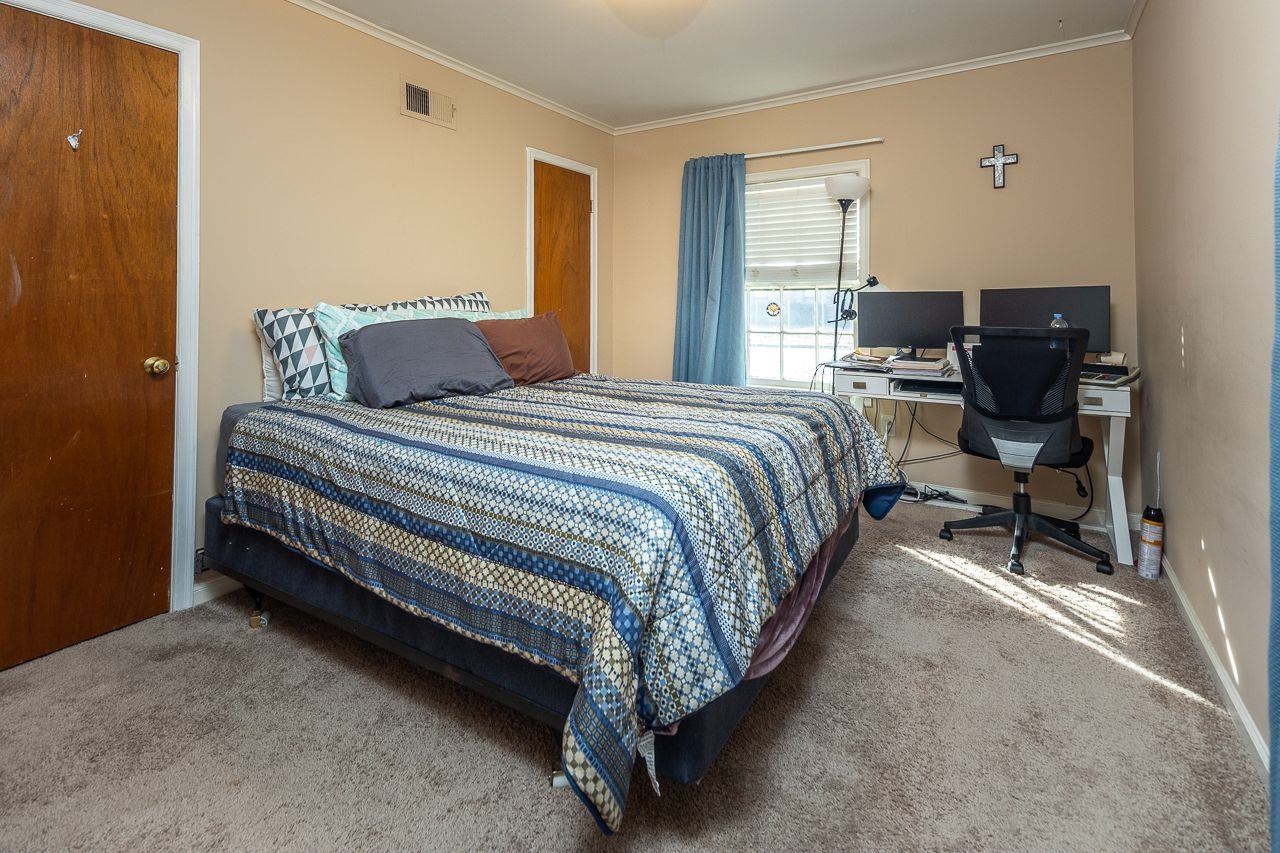 1632 Ivy Road Memphis, TN 38117 - Photo 12 of 14 a bed sitting in a bedroom next to a window with pc on the table
