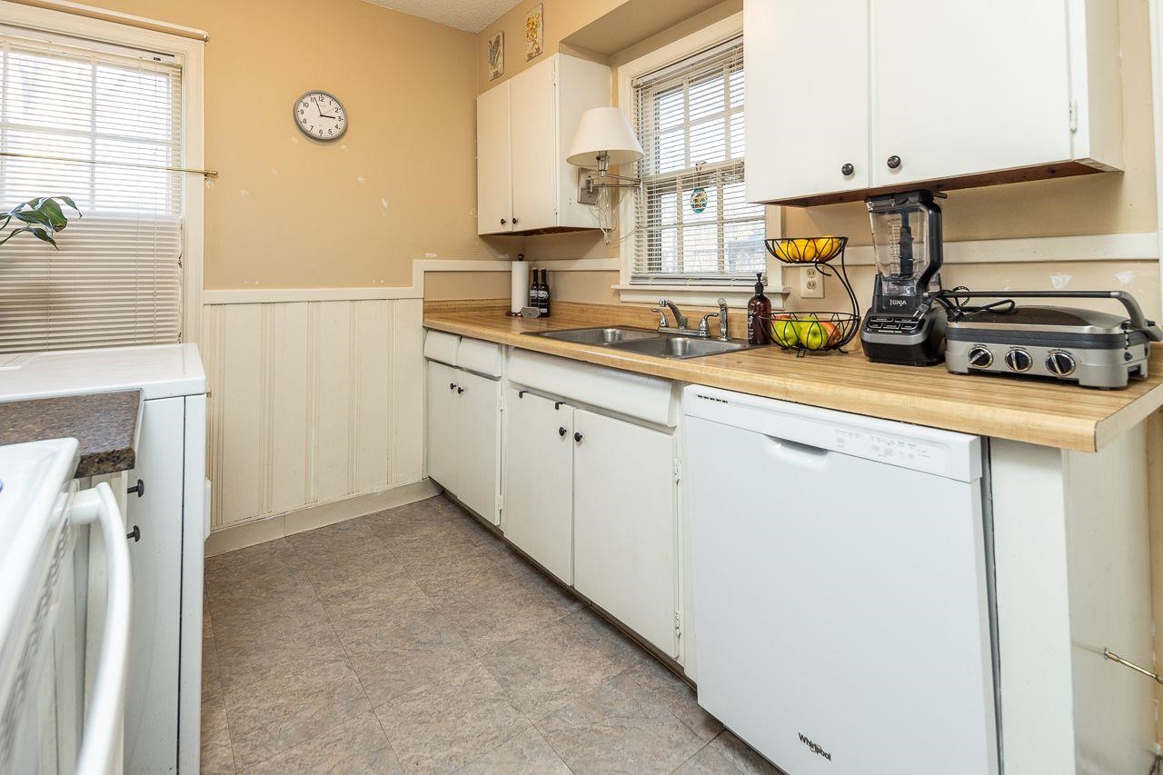 1632 Ivy Road Memphis, TN 38117 - Photo 8 of 14 a kitchen with a refrigerator a stove a sink and cabinets