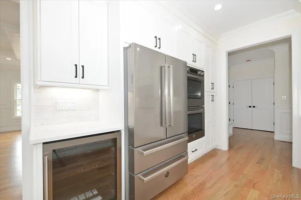 a view of kitchen with refrigerator and microwave