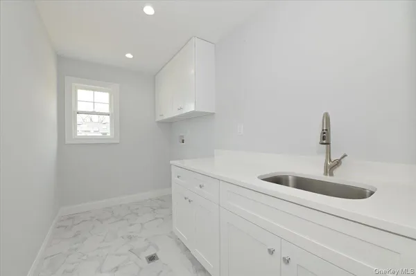 a kitchen with a sink and cabinets